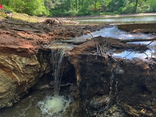 stormwater erosion of retention pond dam